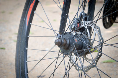 Close-up of bicycle wheel on field