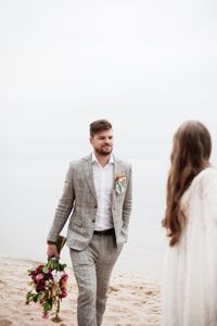 Bride and bridegroom at beach during wedding ceremony