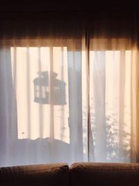 Close-up of shadow on curtain at home