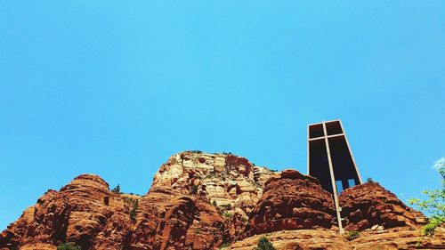 Low angle view of trees against clear blue sky