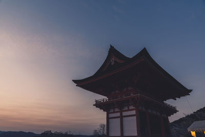 Low angle view of silhouette building against sky at sunset