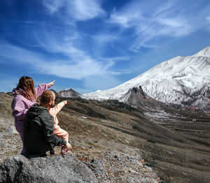 Rear view of woman standing on mountain