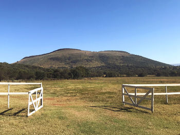 Scenic view of field against clear blue sky