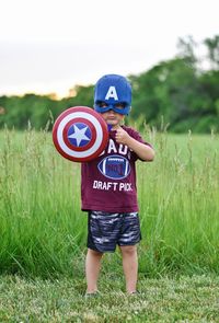 Full length of a boy holding a field