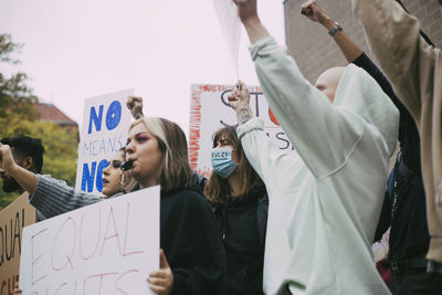 Female activist with equal rights protesting during covid-19