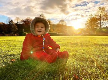 Cute girl sitting on field