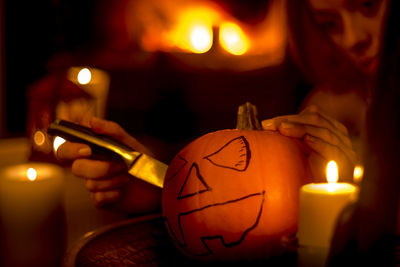 Close-up of lit candles in the dark