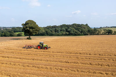 View of tractor on field against sky