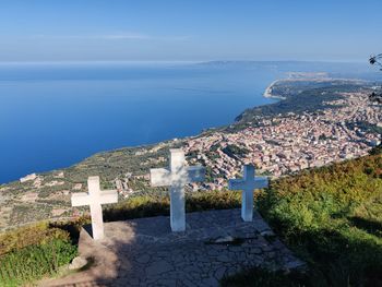 High angle view of townscape by sea against sky