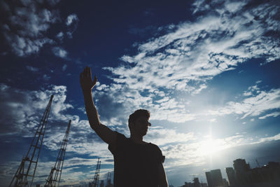 Silhouette man standing against sky during sunset