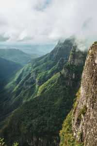 Fortaleza canyon with steep rocky cliffs and forest in a cloudy day near cambará do sul. brazil.