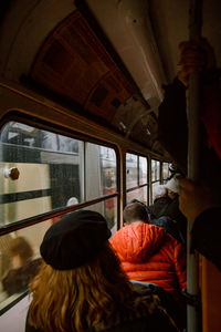 Rear view of people sitting in train