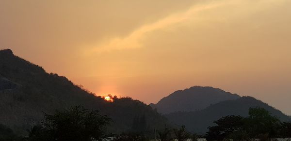 Scenic view of silhouette mountains against sky during sunset