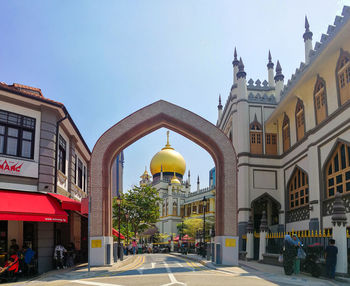 Street amidst buildings against clear sky