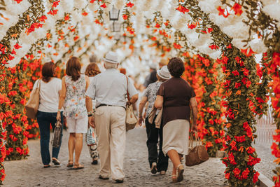 Rear view of people walking on street