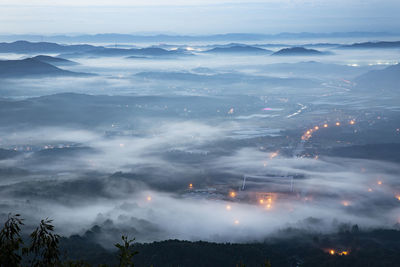 High angle view of illuminated mountains against sky