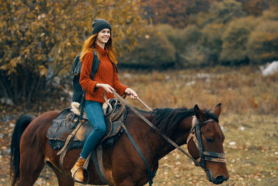 Man riding horse in autumn