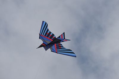 Low angle view of airplane flying in sky