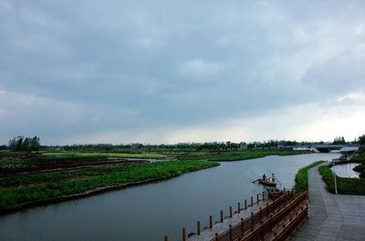 Scenic view of lake against cloudy sky