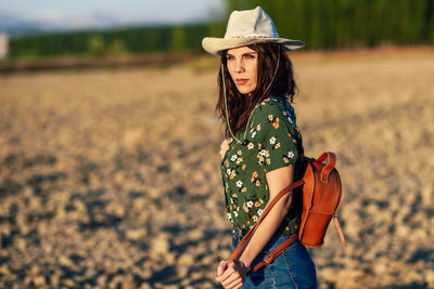 Woman looking away while standing on land 