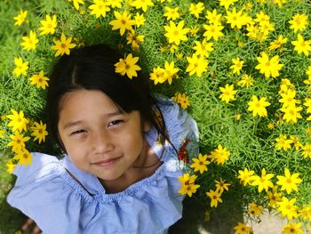 Portrait of girl by yellow flowers