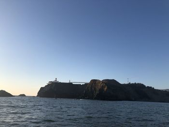 Scenic view of sea against clear blue sky