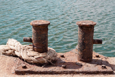 Close-up of rusty wooden post in sea