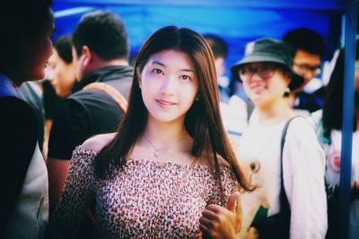 Portrait of smiling young women standing outdoors