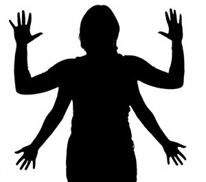 Low angle view of silhouette person standing against white background