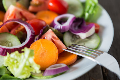 Close-up of chopped fruits in plate on table