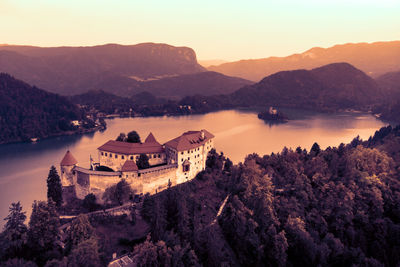 High angle view of trees and mountains against sky during sunset