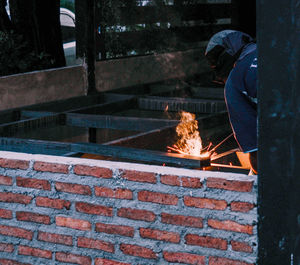 Man working on brick wall