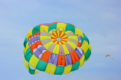 Low angle view of parachute against sky