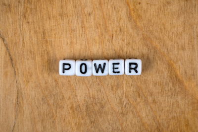 Directly above shot of text written on wooden surface