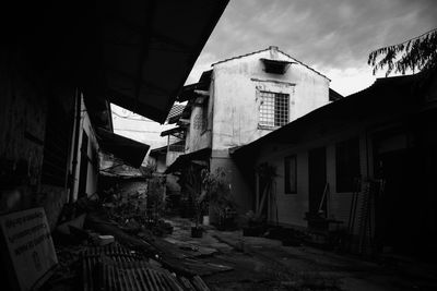 Low angle view of abandoned buildings against sky