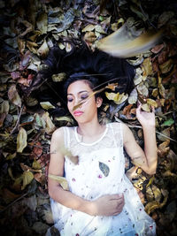 High angle view of woman standing on autumn leaves