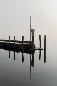 Pier over lake against clear sky