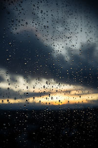 Raindrops on glass window during rainy season