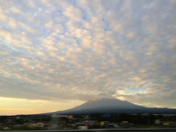 Scenic view of landscape against cloudy sky