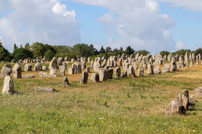 Old ruins on field against cloudy sky