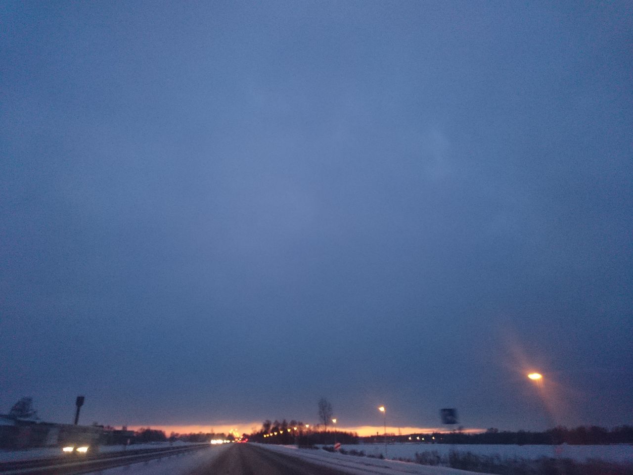 illuminated, night, transportation, road, the way forward, sky, street, dusk, diminishing perspective, copy space, water, clear sky, connection, blue, street light, vanishing point, no people, outdoors, highway, road marking