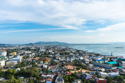 High angle view of buildings and sea against sky