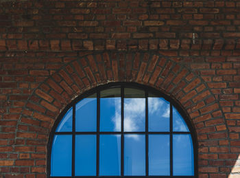 Low angle view of window on brick wall