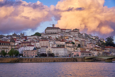 Coimbra city view at sunset with mondego river and beautiful historic buildings, in portugal