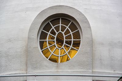 Close-up of bicycle wheel against building