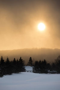 Scenic view of snow covered landscape against sky during sunset