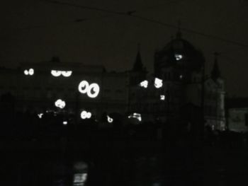 Illuminated city against sky at night