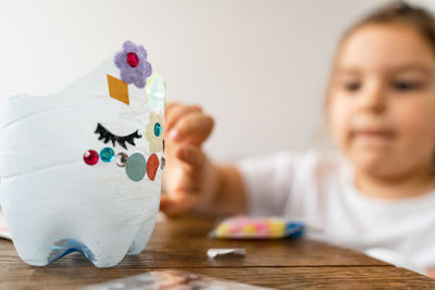 Close-up of girl drawing on table