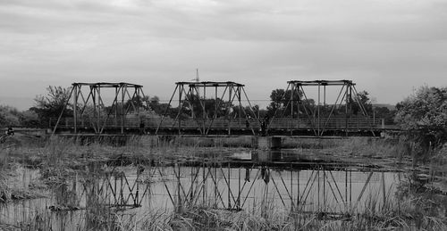 Abandoned built structure in water against sky