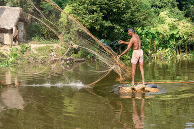 Side view of a man fishing in lake